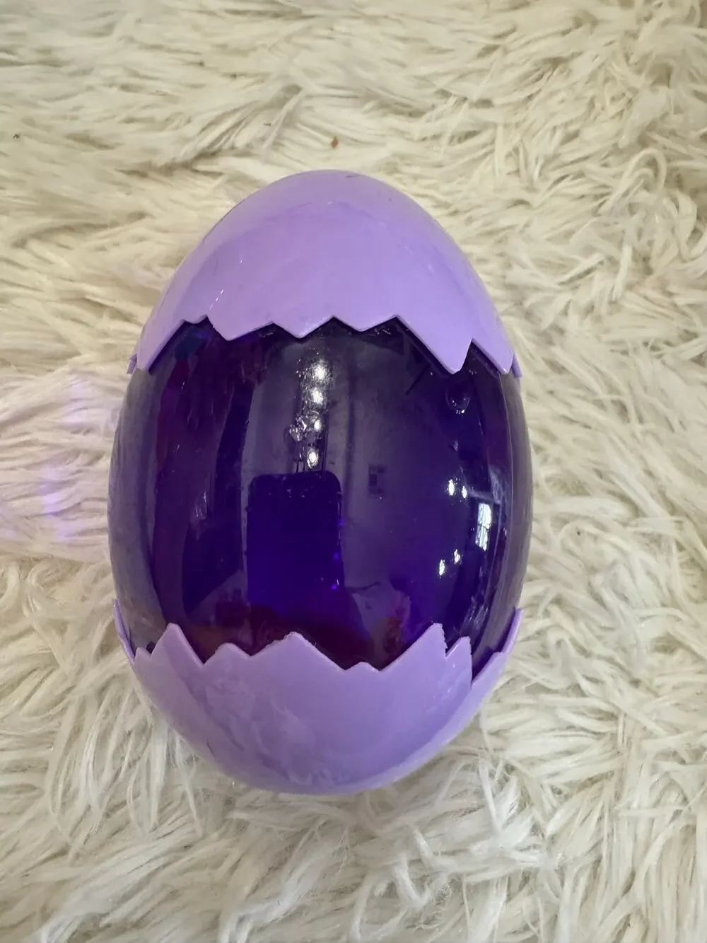 Purple slime dinosaur egg with an assorted dinosaurs inside